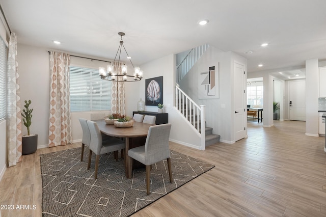 dining room with light wood finished floors, baseboards, stairway, an inviting chandelier, and recessed lighting