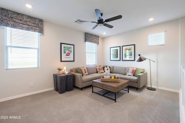 living area featuring recessed lighting, light carpet, and visible vents