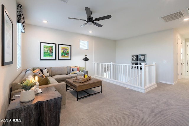 living room with carpet floors, recessed lighting, visible vents, and baseboards