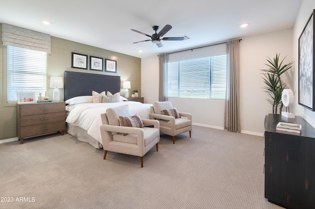 bedroom featuring recessed lighting, light colored carpet, ceiling fan, and baseboards