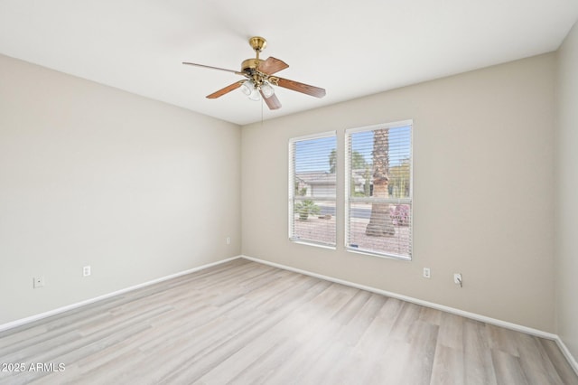 empty room featuring light wood-type flooring, baseboards, and ceiling fan