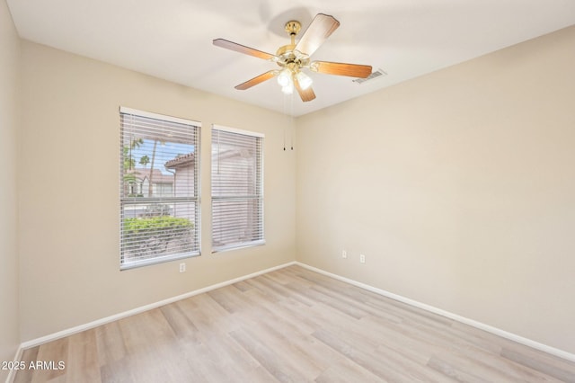 unfurnished room with light wood-type flooring, visible vents, baseboards, and a ceiling fan