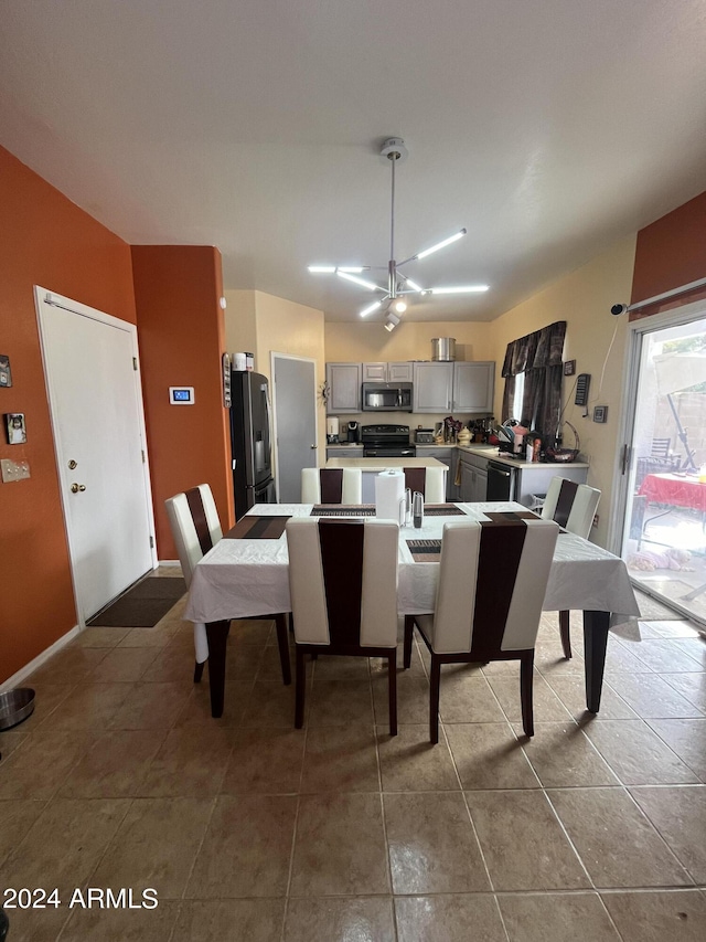 tiled dining area featuring a notable chandelier