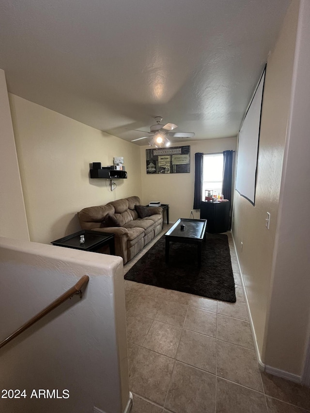 living room featuring light tile patterned floors and ceiling fan