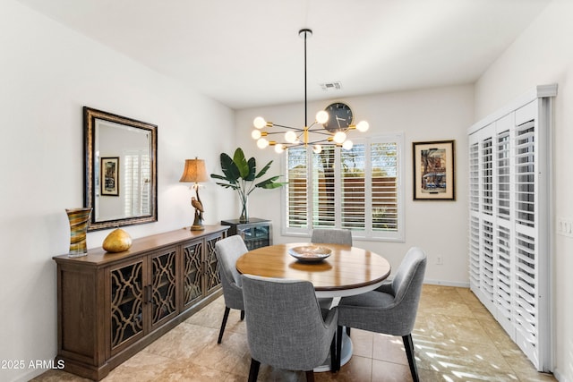 dining area featuring visible vents and a notable chandelier