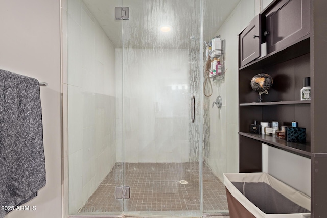 bathroom featuring a shower with door