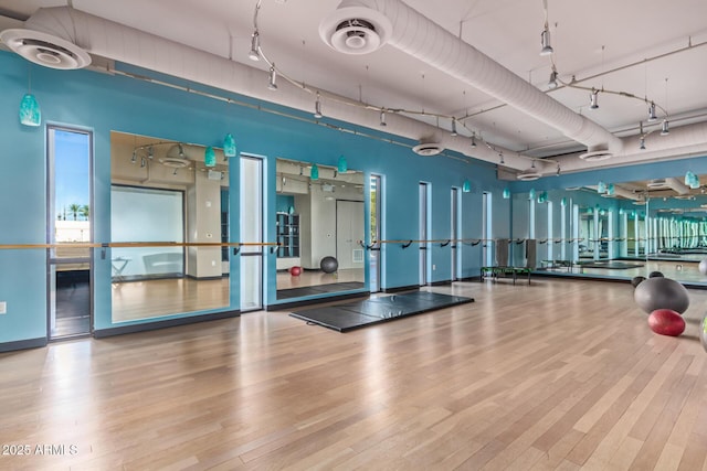 gym with wood-type flooring