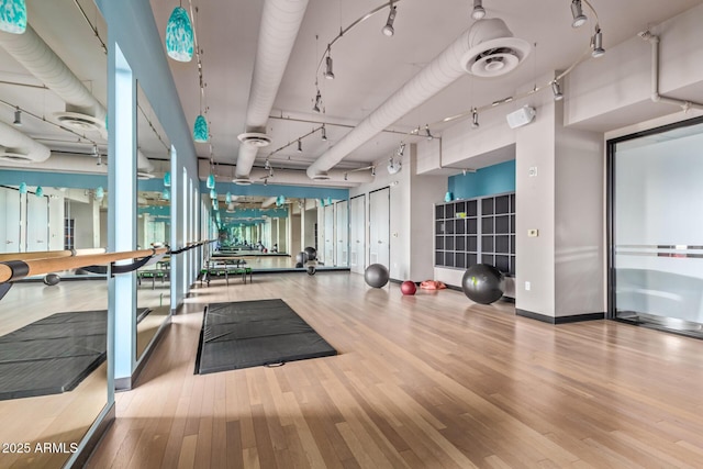 workout area with hardwood / wood-style flooring