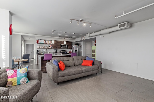 living room featuring rail lighting