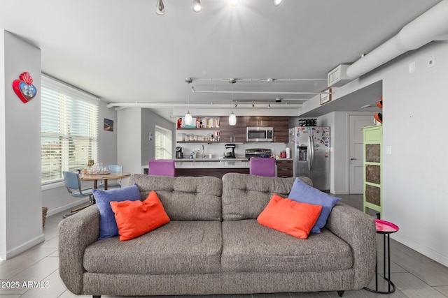 living room featuring sink and track lighting