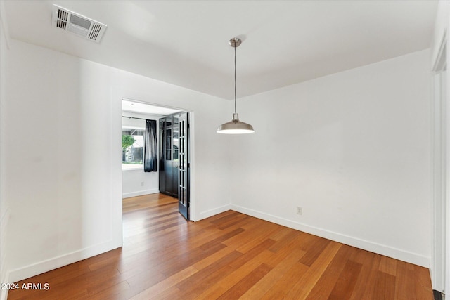 empty room with hardwood / wood-style flooring