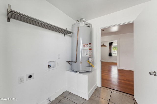 clothes washing area featuring hookup for a washing machine, gas water heater, hookup for an electric dryer, and hardwood / wood-style flooring