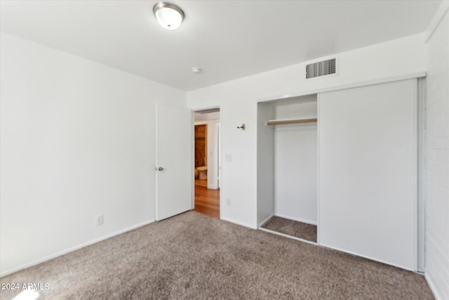 unfurnished bedroom featuring a closet and carpet