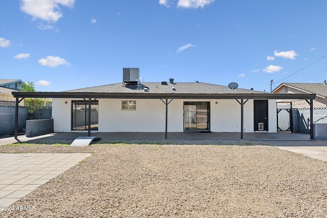 view of front of house featuring cooling unit and a patio