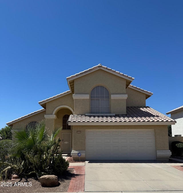 1403 W Goldfinch Way, Chandler, AZ 85286 - mediterranean / spanish home with stucco siding, concrete driveway, and an attached garage