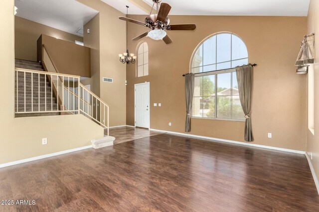 1403 W Goldfinch Way, Chandler, AZ 85286 - unfurnished living room with ceiling fan, stairs, wood finished floors, a towering ceiling, and a chandelier