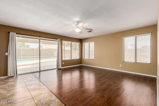 1403 W Goldfinch Way, Chandler, AZ 85286 - empty room with ceiling fan, plenty of natural light, and wood finished floors