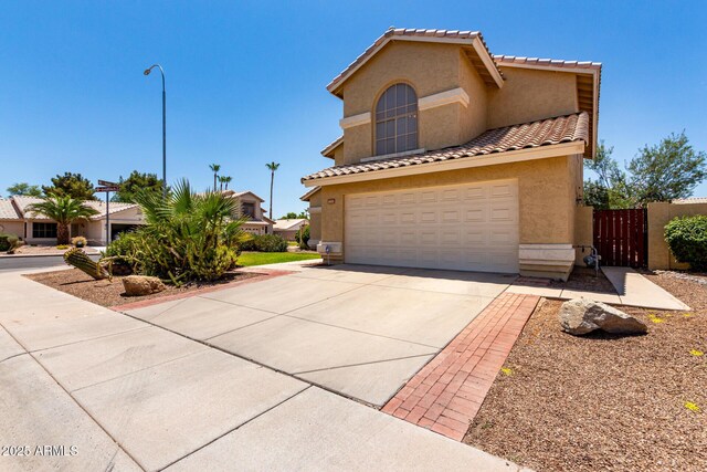 1403 W Goldfinch Way, Chandler, AZ 85286 - view of front of home featuring stucco siding, driveway, a gate, an attached garage, and a tile roof