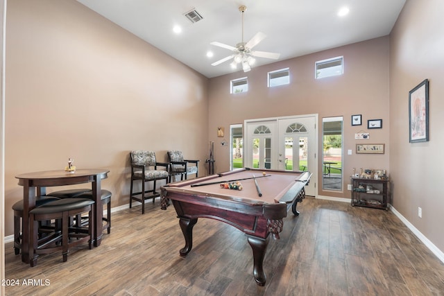 game room with french doors, a towering ceiling, ceiling fan, wood-type flooring, and billiards