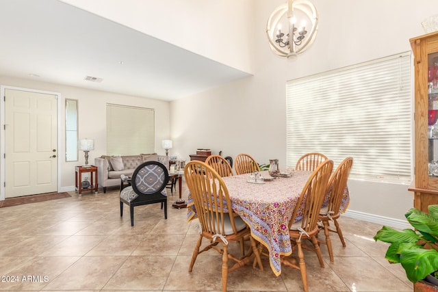 dining area with a chandelier and light tile patterned floors