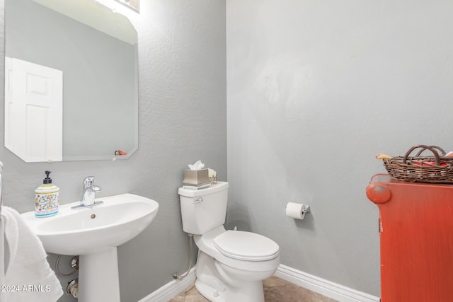 bathroom featuring toilet and tile patterned flooring