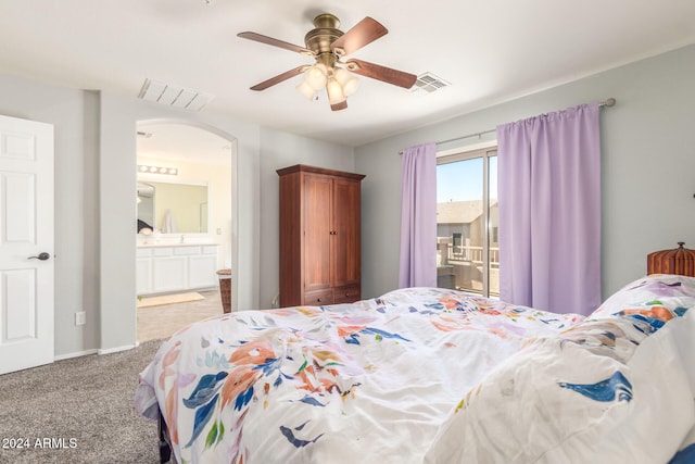 carpeted bedroom with ceiling fan and ensuite bathroom