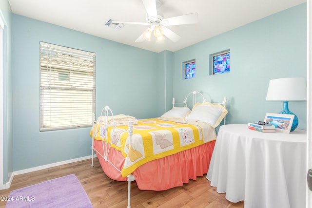 bedroom with ceiling fan and hardwood / wood-style flooring