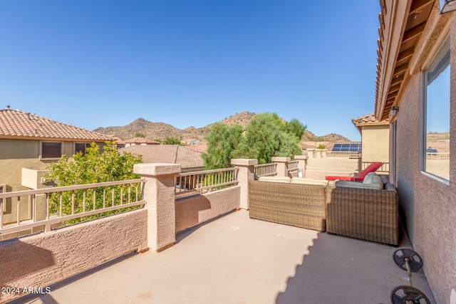 view of patio / terrace with a mountain view and a balcony