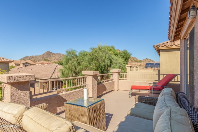 view of patio / terrace featuring an outdoor hangout area, a mountain view, and a balcony