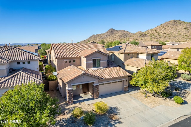 birds eye view of property with a mountain view