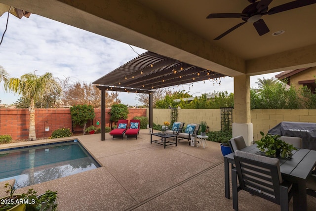 view of pool with a pergola, area for grilling, ceiling fan, and a patio area