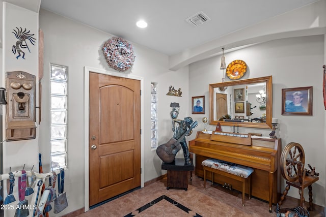 foyer entrance featuring tile patterned floors, recessed lighting, visible vents, and baseboards