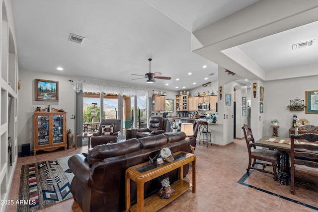 living area with light tile patterned floors, visible vents, lofted ceiling, recessed lighting, and ceiling fan