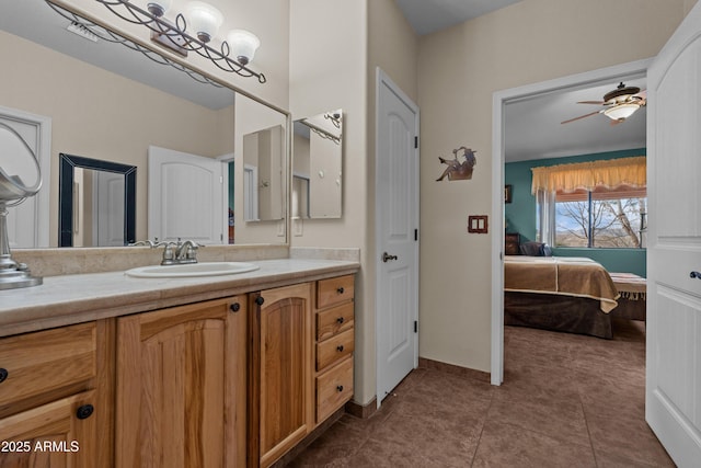 ensuite bathroom with tile patterned floors, ensuite bath, baseboards, ceiling fan, and vanity