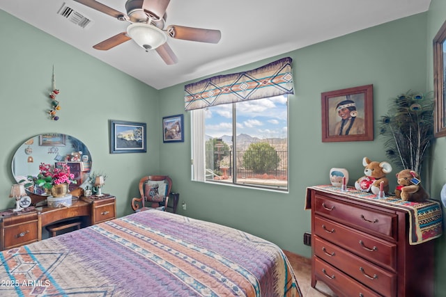 bedroom with visible vents, carpet floors, a ceiling fan, and a mountain view