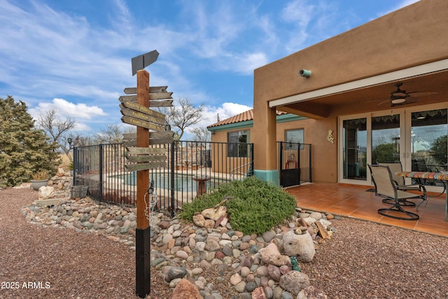 view of pool featuring a patio area, ceiling fan, and fence