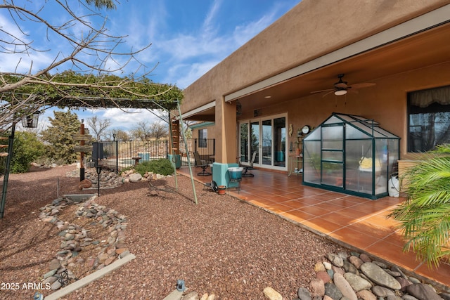 view of yard with ceiling fan, a patio, and fence