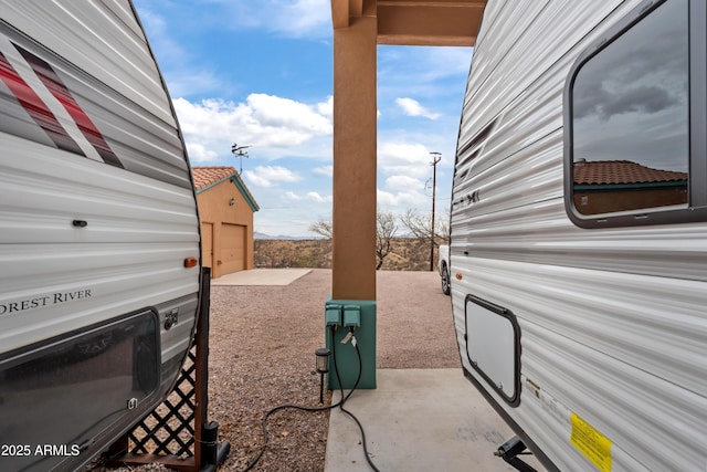 view of patio featuring an outbuilding