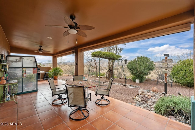 view of patio featuring outdoor dining area and a ceiling fan