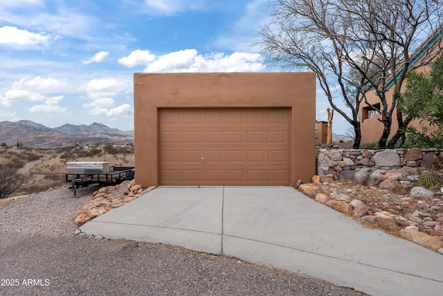 garage featuring a mountain view and driveway