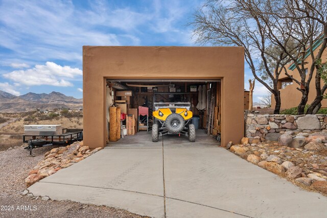 detached garage featuring a mountain view