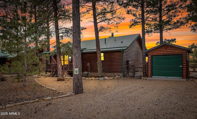 log home with a garage and an outdoor structure