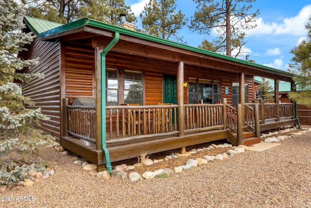 log home with covered porch