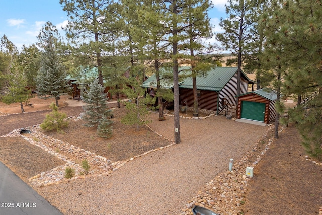 view of front of property featuring a garage and an outdoor structure