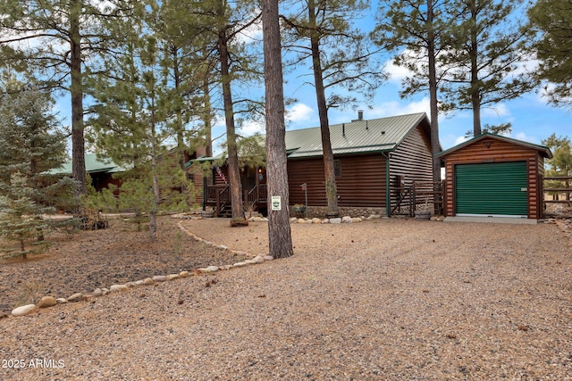 view of front facade featuring a garage and an outdoor structure