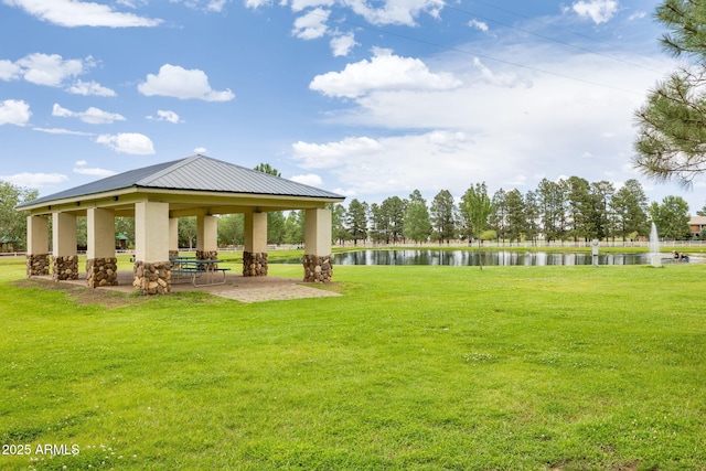 view of property's community featuring a gazebo, a water view, and a yard