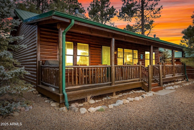 property exterior at dusk with a porch