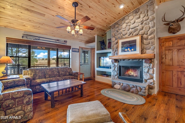 living room with vaulted ceiling, a stone fireplace, hardwood / wood-style floors, and wooden ceiling