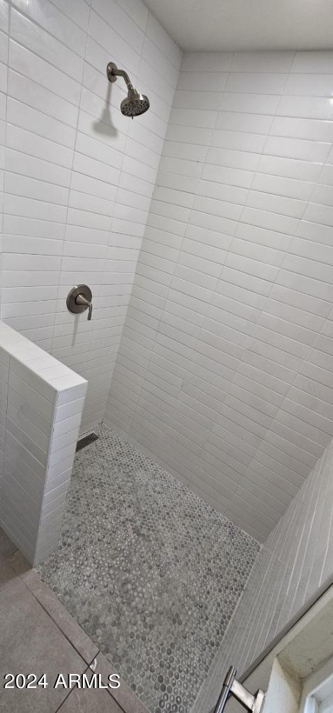 bathroom with tiled shower