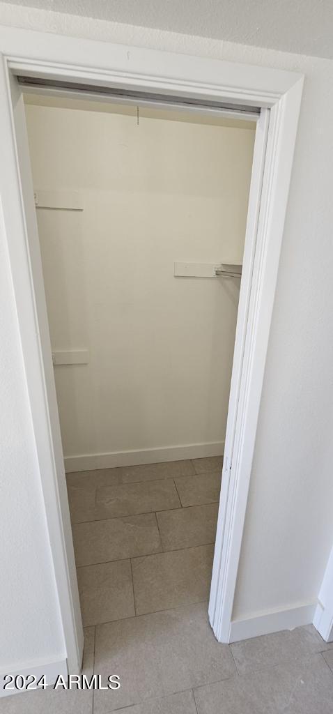 spacious closet with light tile patterned floors